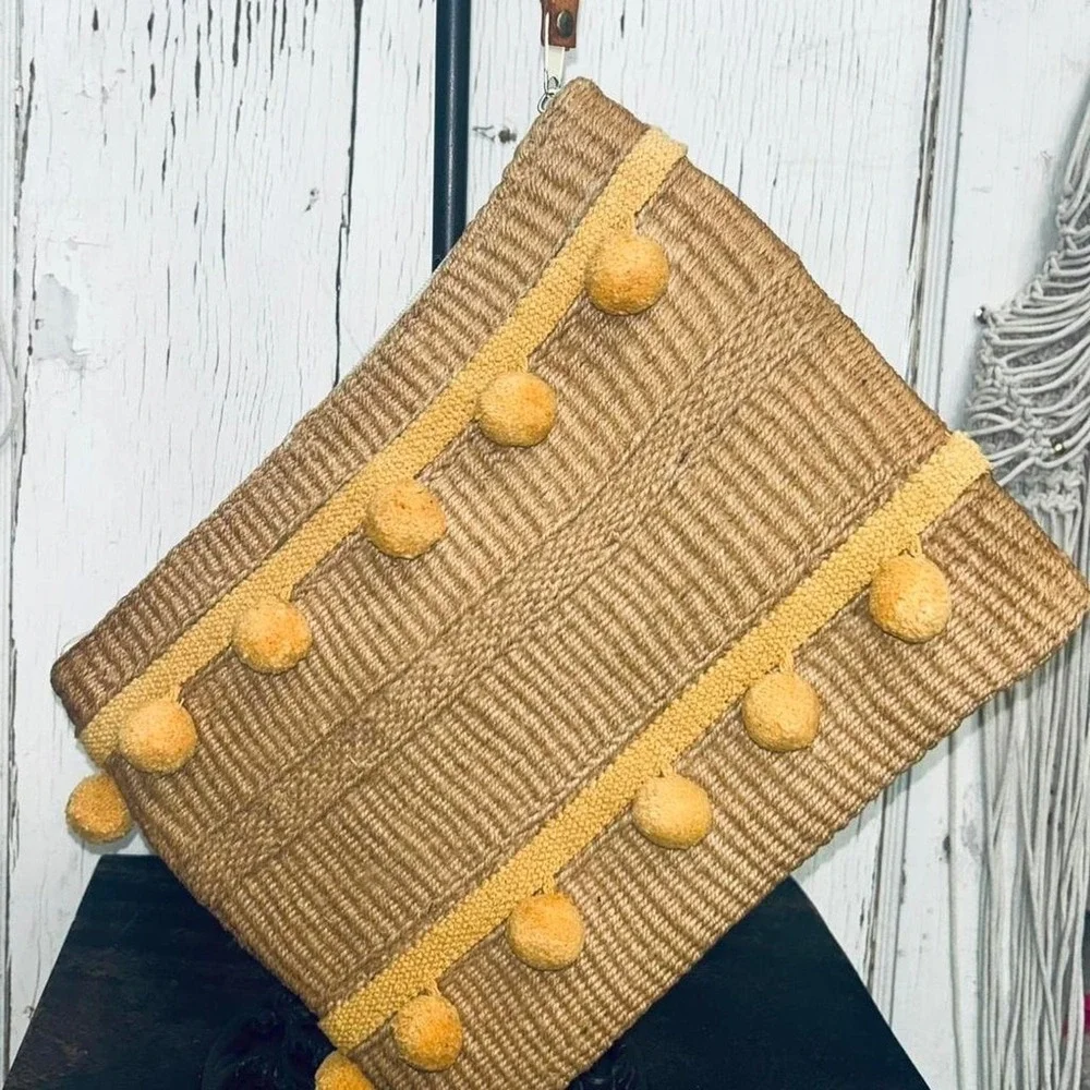 Yellow pom pom raffia clutch bag